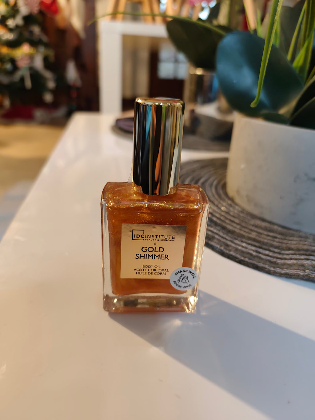 Huile pour le corps 50ml pailletée dorée dans bouteille en verre